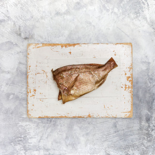 Buy whole smoked snapper from Sanford and Sons. Half Snapper on chopping board. Perfect for smoked fish dips.