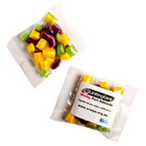 Brightly coloured humbugs in a branded bag, featuring shades of yellow, purple, and green.