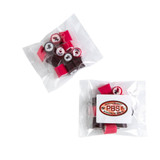 Branded rock candy in a clear bag, featuring pink and dark red pieces, along with a sticker on the packaging.