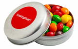 A metal tin filled with colourful Skittles, featuring a red lid with a logo.