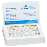 A white box containing mints, featuring a logo and a business card on the lid.