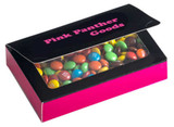 A box with a black lid contains colourful chocolate-coated candies, featuring a pink base and a logo on the lid.