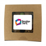 A brown box containing cookies, featuring a clear window and a logo sticker on the front.