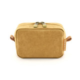 A tan Kraft paper cosmetic bag with a zip closure and leather accents, featuring a branding label.