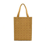 A kraft paper tote bag in a light brown hue with patterned details and sturdy handles. It features a logo.