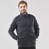 A man wearing a navy polar fleece jacket with a full zip, featuring a collar and side pockets.