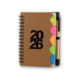 A brown spiral-bound notebook with a ruler and colourful tabs, featuring the year "2026" on the cover.