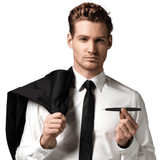 A man in a suit holds a black pen while draping his jacket over one shoulder. The pen has a sleek design and branding.