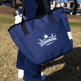 A blue cooler tote with black straps, featuring a logo and a drink bottle at the side.