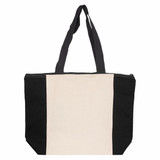A large tote bag featuring a cream centre and black sides, with two sturdy shoulder straps and a zip closure.