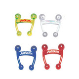 A set of four massagers in yellow, clear, blue, and red, each featuring a logo.