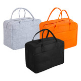 Three travel bags in grey, orange, and black felt material, featuring dual handles and a structured design.