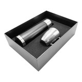 A drink bottle in black and a silver cup, both presented in a sleek gift box with foam cushioning.