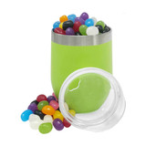 A green coffee cup filled with colourful jelly beans, next to a clear jar containing more jelly beans.