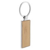 A bamboo keyring with a silver metal ring, showcasing a smooth rectangular shape.
