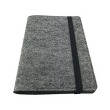 A grey felt notebook with a black elastic band, featuring a minimalistic design and a logo.