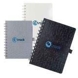 A set of three spiral-bound notebooks in grey, white, and black, each featuring a logo on the front cover.