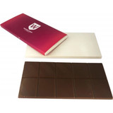 A chocolate bar in a wrapper with a white and pink design. The bar is dark brown, divided into segments.