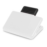 A white magnetic clip with a black gripping section. The clip is designed for holding papers or notes. A white magnetic clip with a black gripping section. The clip is designed for holding papers or notes.