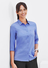 A blue women's button-up shirt with 3/4 sleeves and a chest pocket, displayed on a model.
