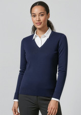 A women's navy V-neck knitted pullover worn over a white collared shirt, featuring a fitted design and long sleeves.