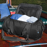 A black duffle bag with clothes inside, featuring a zippered top and a logo on the side.