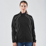 A woman wearing a black training jacket with white accents, featuring a zip front and high collar, and a logo.
