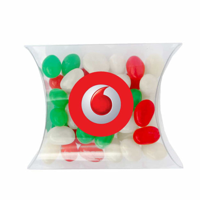 A transparent pillow pack contains red, green, and white mini jelly beans, featuring a logo on the front.