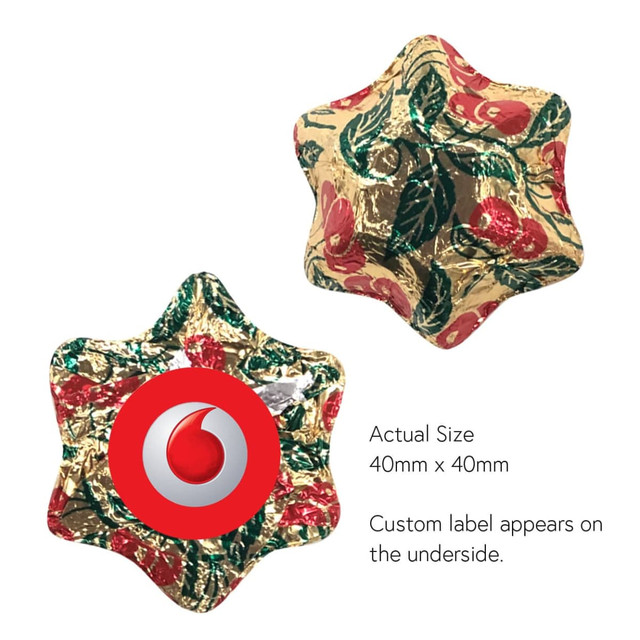 A gold, star-shaped decoration with red and green floral patterns. It has a logo on the underside. A gold, star-shaped decoration with red and green floral patterns. It has a logo on the underside.