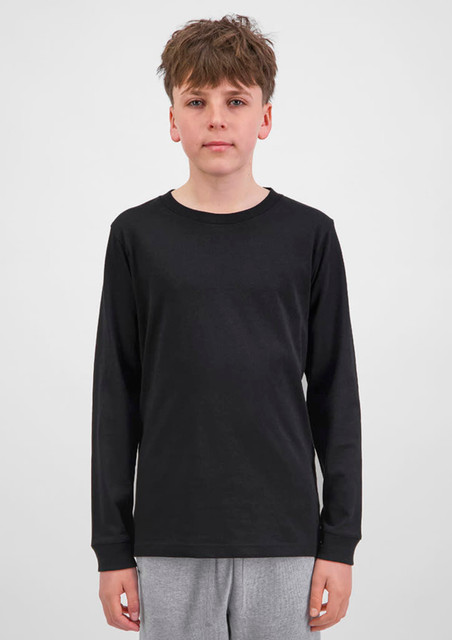A youth long sleeve tee in black, featuring a simple design and long sleeves. The model stands against a plain background.