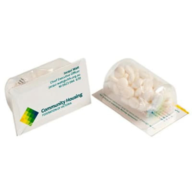 A container of white mints alongside a business card, featuring a logo and presented in a clear package.