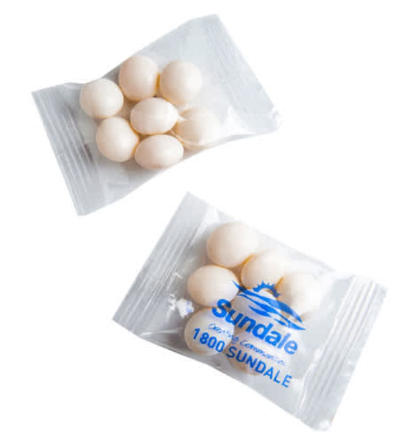 A clear bag containing white mint sweets, featuring a logo and arranged neatly.