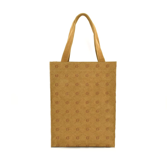 A kraft paper tote bag in a light brown hue with patterned details and sturdy handles. It features a logo.