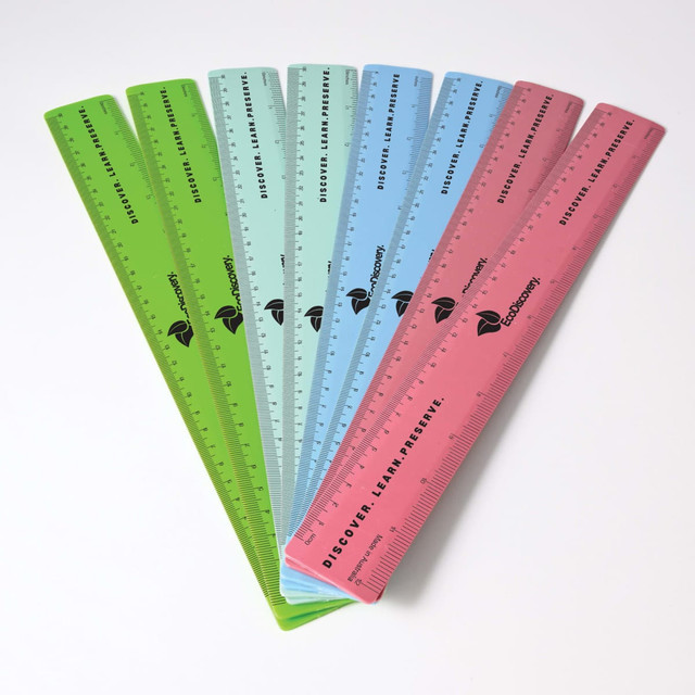A collection of recycled plastic rulers in green, blue, and pink, featuring a logo and measurement markings. A collection of recycled plastic rulers in green, blue, and pink, featuring a logo and measurement markings.
