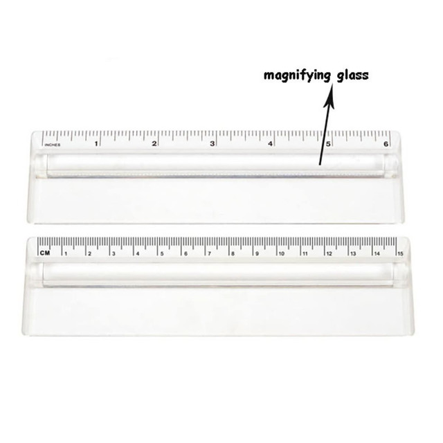 A transparent 15cm ruler featuring a magnifying glass, with clear measurement markings in centimetres and inches.