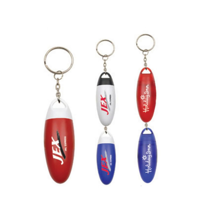 A set of four pill box keychains in red, white, and blue, featuring various logos and keyring attachments.