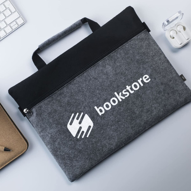 A grey felt carry case with a black top and a logo, featuring a zip closure and a handle.