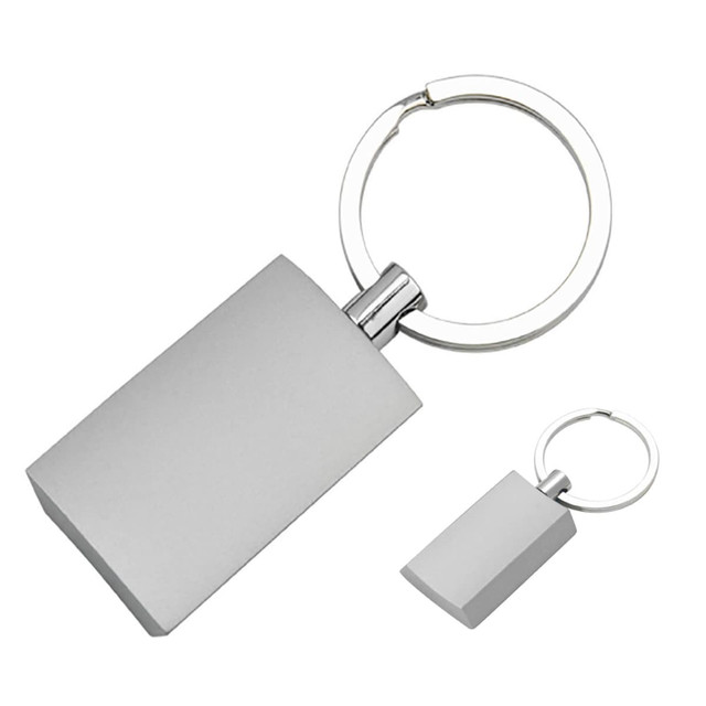 A silver rectangular key ring with a metal attachment and a simple design. A silver rectangular key ring with a metal attachment and a simple design.
