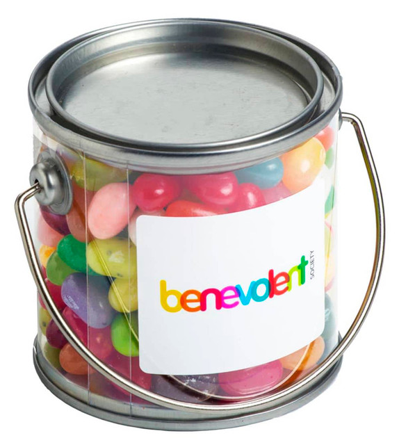 A small clear PVC bucket filled with colourful JELLY BELLY jelly beans, featuring a silver handle and a branding label.
