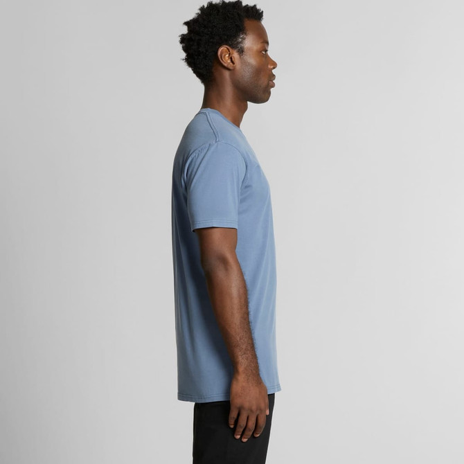 A casual blue T-shirt featuring a simple design and a logo, modelled by a person from the side.