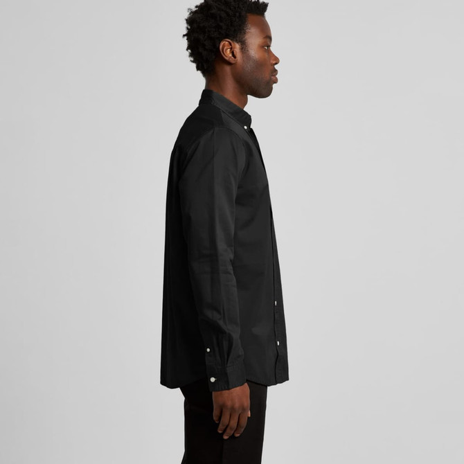 A black button-up denim wash shirt displayed on a male model from the side, featuring a collar and long sleeves.