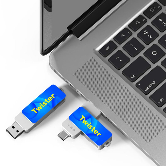 A Twister Type-C Flash Drive in silver and blue, connected to a laptop keyboard. Features a logo on the drive.