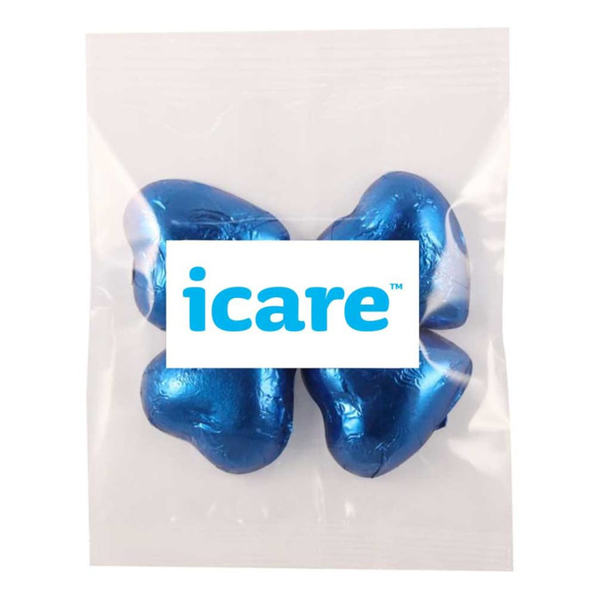 A clear pouch containing three star-shaped chocolates wrapped in shiny blue foil, with a logo visible on the packaging.