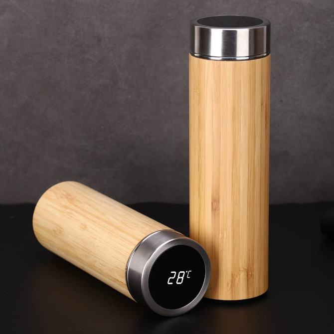A drink bottle featuring a bamboo exterior and stainless steel accents, with a digital display showing temperature.