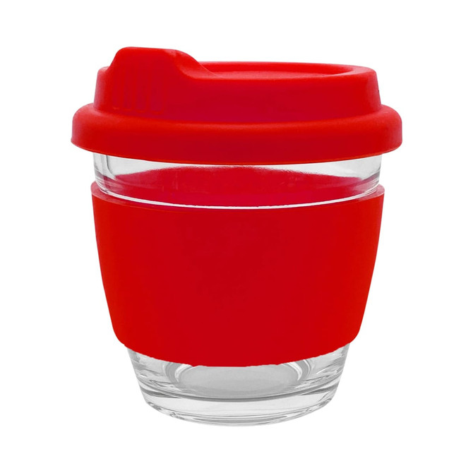 A reusable coffee cup with a clear glass body and a bright red silicone sleeve and lid. The cup features a logo.