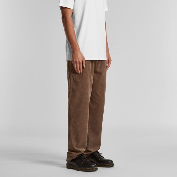 A pair of brown cord pants displayed on a model, featuring a relaxed fit and casual styling.