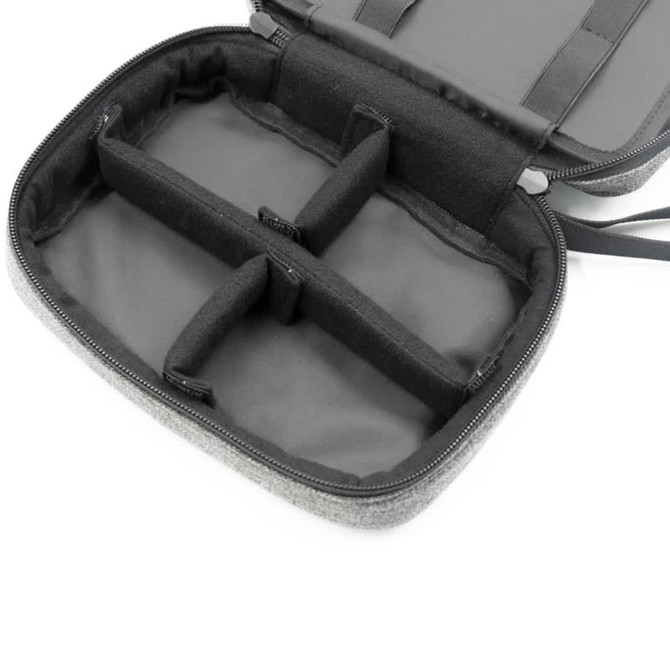 A grey toiletry bag featuring multiple compartments, with a zippered closure and an interior lining.