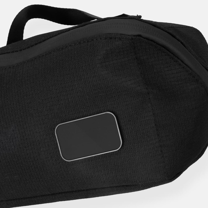 A black toiletry bag featuring a smooth panel and a sturdy handle, ideal for travel and storage.