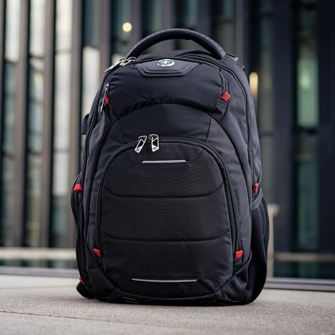 A black backpack with red accents, featuring multiple compartments and a logo on the front.