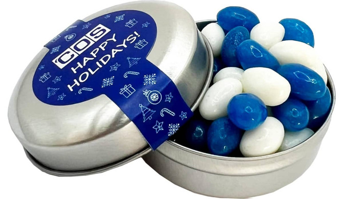 A tin container with a silver finish holds blue and white mini jelly beans. The lid has a festive design.